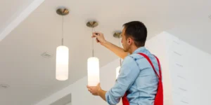 electrician installing ceiling lamp electrician installing ceiling lamp