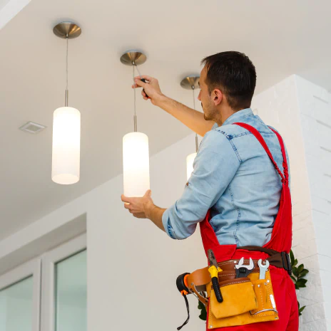 service 3 electrician installing ceiling lamp